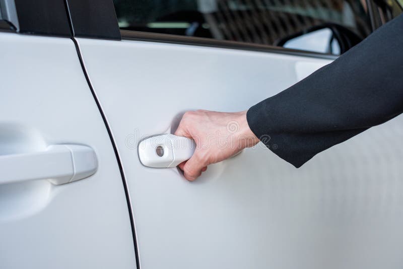 Formal hand on handle opening a car door stock image Formal hand on handle opening a car door stock image