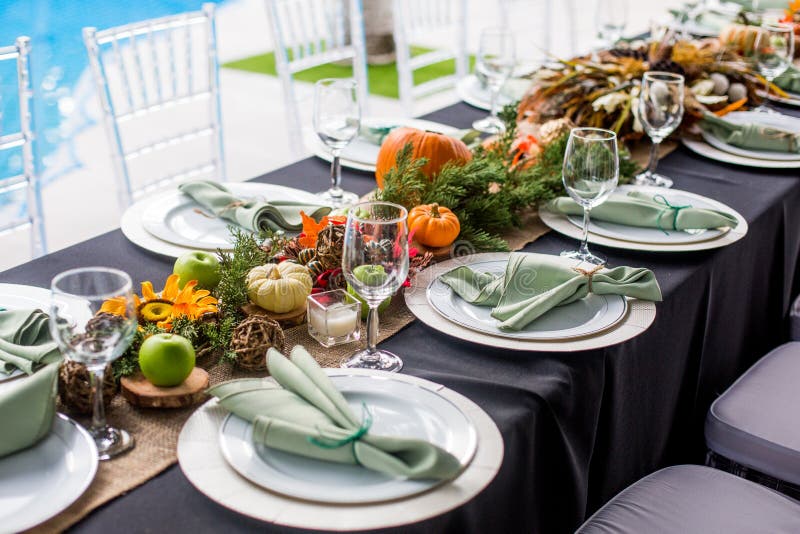 Formal Thanksgiving table and chavari chairs in the fall family gathering for holiday dinner