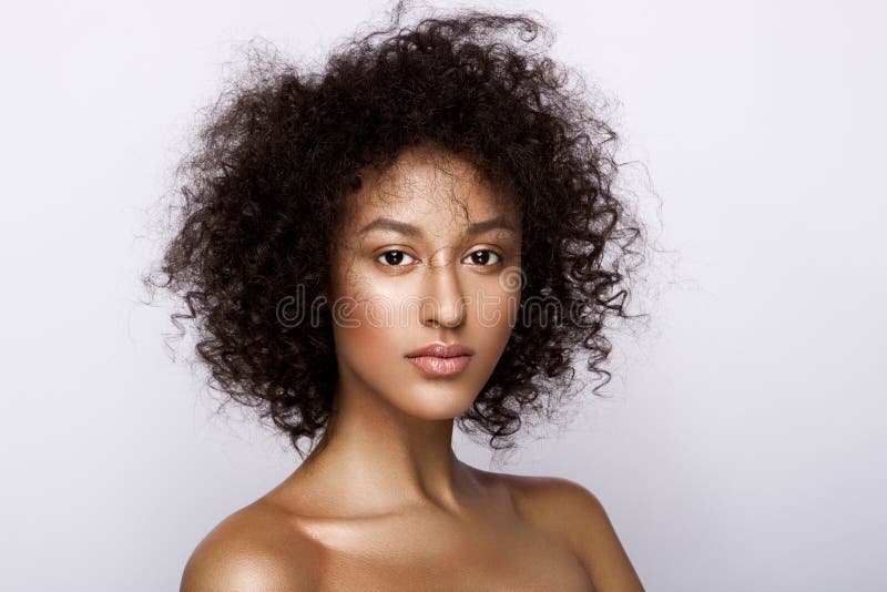 Fashion studio portrait of beautiful african american woman with perfect smooth glowing mulatto skin, nude make up. Fashion studio portrait of beautiful african american woman with perfect smooth glowing mulatto skin, nude make up