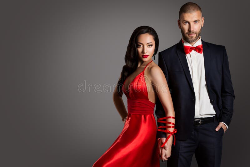Forme los brazos de los pares, de la mujer y del hombre limitados por la cinta, traje rojo del negro del vestido foto de archivo Forme los brazos de los pares, de la mujer y del hombre limitados por la cinta, traje rojo del negro del vestido foto de archivo