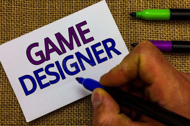 Text sign showing Game Designer. Conceptual photo Campaigner Pixel Scripting Programmers Consoles 3D Graphics Man hand holding marker white paper communicating ideas Jute background. Text sign showing Game Designer. Conceptual photo Campaigner Pixel Scripting Programmers Consoles 3D Graphics Man hand holding marker white paper communicating ideas Jute background