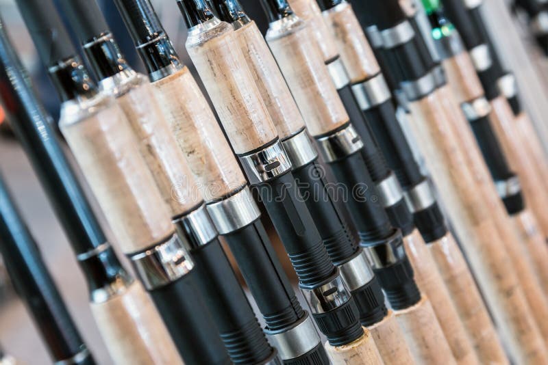 Forms of fishing rods and spinning rods on the counter in the store