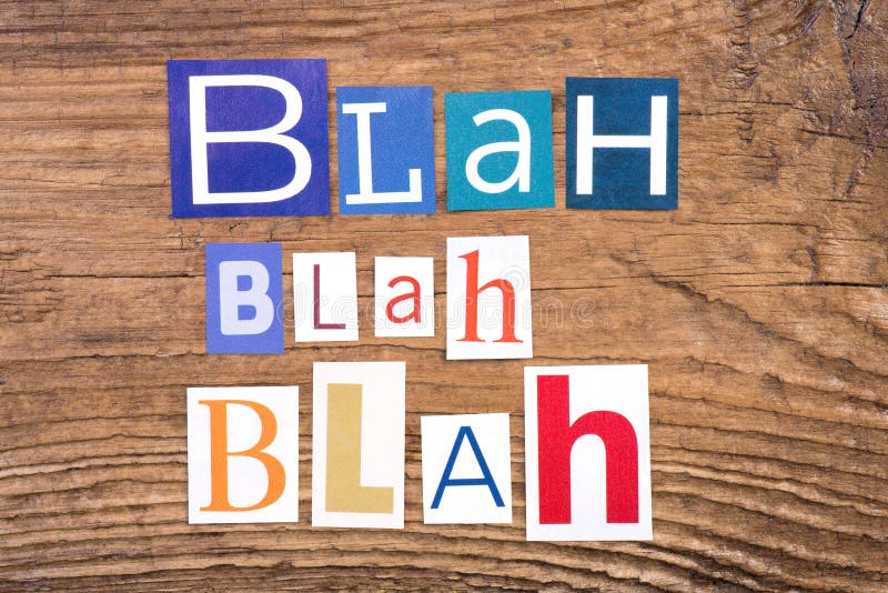 Phrase `Blah, blah, blah` in cut out magazine letters on wooden background. Phrase `Blah, blah, blah` in cut out magazine letters on wooden background