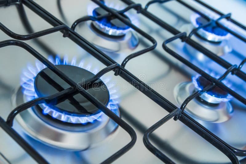 Fornello con le fiamme blu del gas fotografie stock libere da diritti Fornello con le fiamme blu del gas fotografie stock libere da diritti
