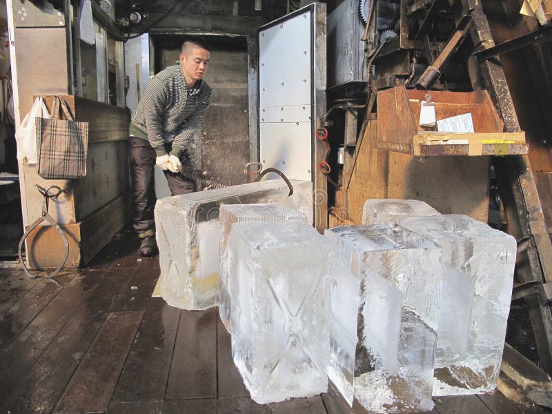 TOKYO- NOVEMBER 20: Ice block vendor at Tsukiji Wholesale Seafood and Fish Market in Tokyo Japan on November 20, 2009. Tsukiji Market is the biggest wholesale fish and seafood market in the world. TOKYO- NOVEMBER 20: Ice block vendor at Tsukiji Wholesale Seafood and Fish Market in Tokyo Japan on November 20, 2009. Tsukiji Market is the biggest wholesale fish and seafood market in the world.