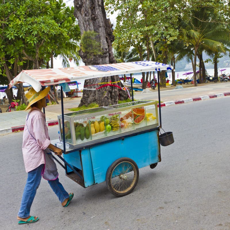 PATONG, PHUKET, THAILAND - JUN 6, 2011: A fruit vendor marketing his products at Patong, Phuket, on June 6, 2011. PATONG, PHUKET, THAILAND - JUN 6, 2011: A fruit vendor marketing his products at Patong, Phuket, on June 6, 2011.