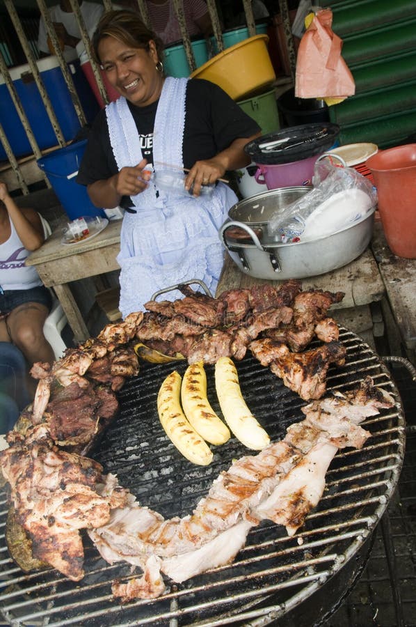 LEON, NICARAGUA APRIL 2010: Street food vendor cooking beef, chicken, pork and plantains at outdoor food stand in Leon, Nicaragua on April 16, 2010. LEON, NICARAGUA APRIL 2010: Street food vendor cooking beef, chicken, pork and plantains at outdoor food stand in Leon, Nicaragua on April 16, 2010.