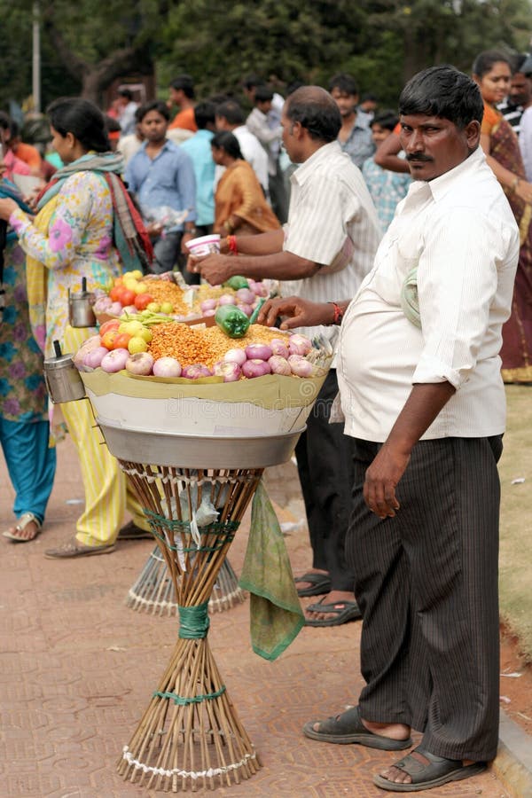 Indian fast food /snacks vendor in a busy road.Common scene in crowded public events,cermonies and celebrations.Photo taken September 11th,2011-Hyderabad,AP,India. Indian fast food /snacks vendor in a busy road.Common scene in crowded public events,cermonies and celebrations.Photo taken September 11th,2011-Hyderabad,AP,India