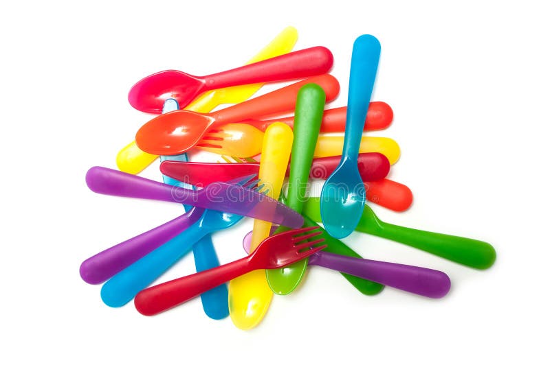 Forquilhas plásticas do bebê colorido empilhadas no fundo branco imagens de stock royalty free Forquilhas plásticas do bebê colorido empilhadas no fundo branco imagens de stock royalty free