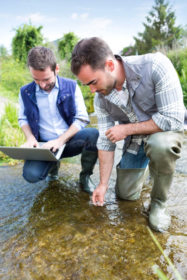 View of a Scientist and biologist working together on water analysis. View of a Scientist and biologist working together on water analysis