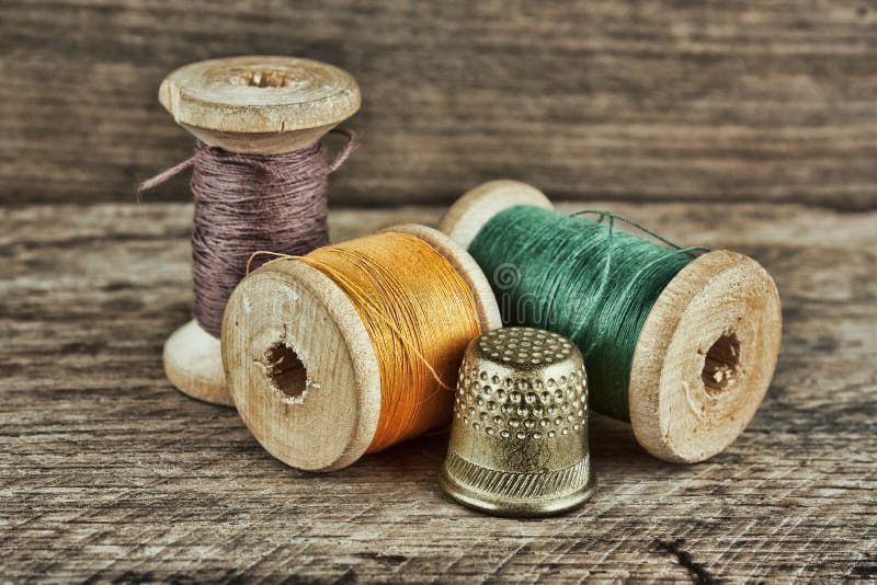 still life of spools of thread on a wooden background. still life of spools of thread on a wooden background