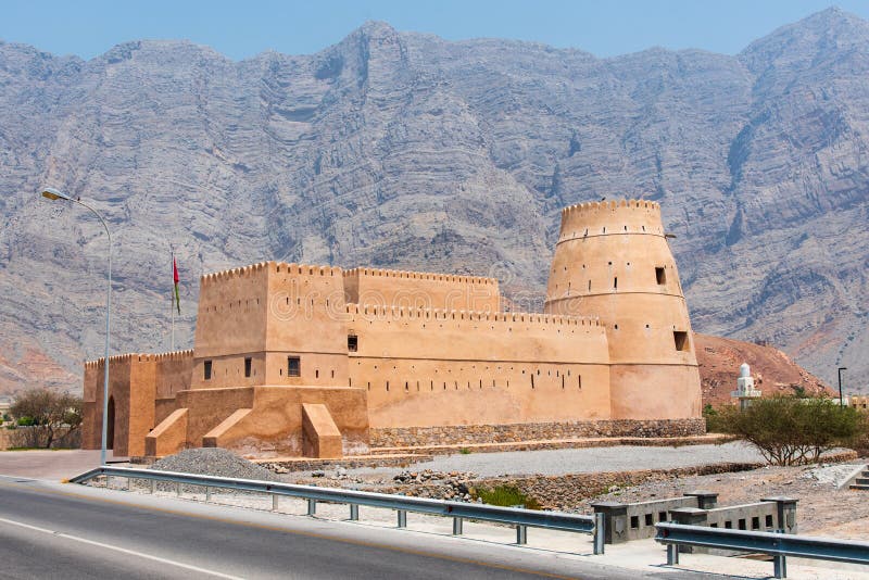 Bukha fort near Khasab in Musandam Oman. Surrounded by rocks and scenery, middle, east, fortress, architecture, museum, landmark, castle, blue, background, desert, beautiful, day, travel, outdoor, sunny, mountain, antique, heritage, old, flag, landscape, arabia, building, house, tower, wall, dry, historic, monument, attraction, gulf, arabian, arid, peninsula, emirate, jabal, uae, dubai, sandstone. Bukha fort near Khasab in Musandam Oman. Surrounded by rocks and scenery, middle, east, fortress, architecture, museum, landmark, castle, blue, background, desert, beautiful, day, travel, outdoor, sunny, mountain, antique, heritage, old, flag, landscape, arabia, building, house, tower, wall, dry, historic, monument, attraction, gulf, arabian, arid, peninsula, emirate, jabal, uae, dubai, sandstone
