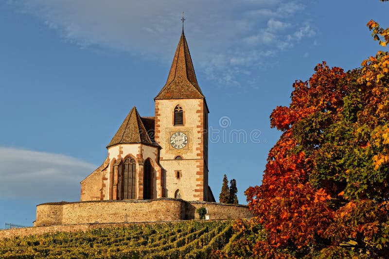 Fortified church of the Alsatian village of Hunawihr and fall colors. Fortified church of the Alsatian village of Hunawihr, surrounded by vineyards, with stock photography Fortified church of the Alsatian village of Hunawihr and fall colors. Fortified church of the Alsatian village of Hunawihr, surrounded by vineyards, with stock photography