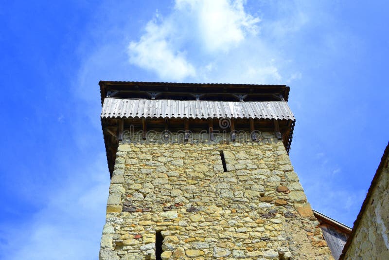 Fortified saxon church. Typical rural landscape and peasant houses in the village Cata, Transylvania, Romania.