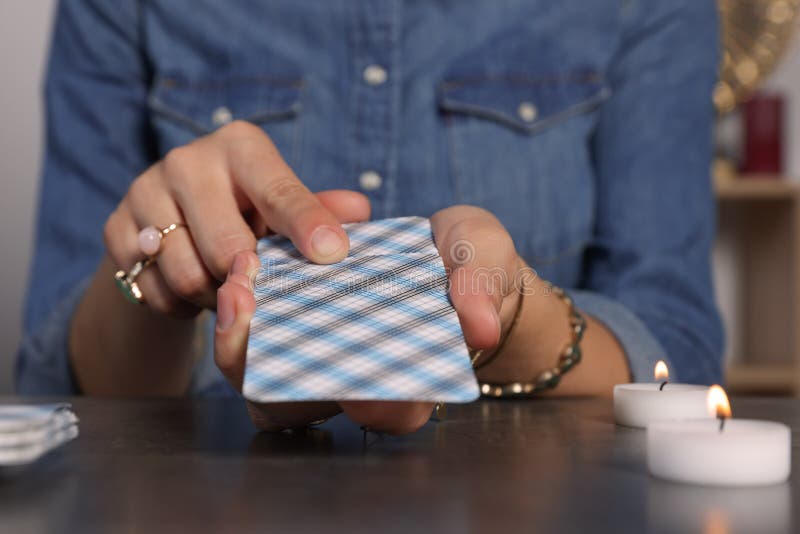 Fortune Teller with Deck of Tarot Cards at Grey Table Indoors, Closeup