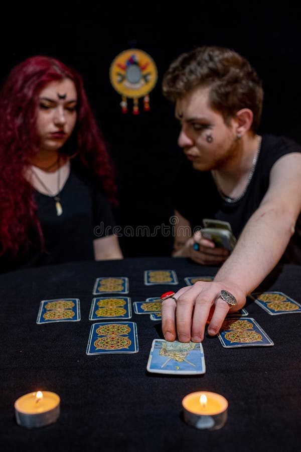 Fortune Teller Using Tarot Cards on Black Background Stock Image