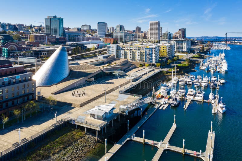 Foss Waterway and Tacoma Skyline. Along the waterway are condominiums and boat docks with a marina.