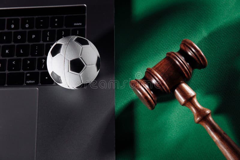 Soccer ball on laptop and judge gavel. Sport betting and law concept. Soccer ball on laptop and judge gavel. Sport betting and law concept.