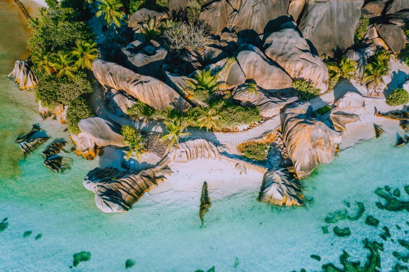 Aerial photo of beautiful famous paradise tropical beach Anse Source D Argent at La Digue island, Seychelles. Summer vacation, travel and lifestyle concept. Bird view. Aerial photo of beautiful famous paradise tropical beach Anse Source D Argent at La Digue island, Seychelles. Summer vacation, travel and lifestyle concept. Bird view.