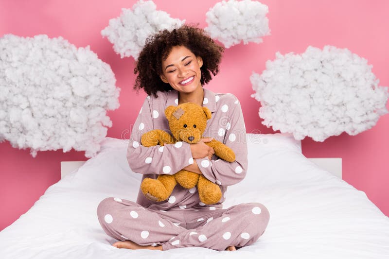 Photo of dreamy excited lady wear pajama relaxing bed hugging teddy bear isolated pink color background. Photo of dreamy excited lady wear pajama relaxing bed hugging teddy bear isolated pink color background.