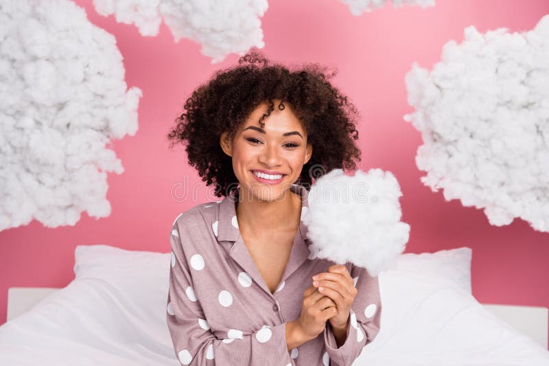Photo of dreamy adorable lady wear pajama holding stick fluffy clouds isolated pink color background. Photo of dreamy adorable lady wear pajama holding stick fluffy clouds isolated pink color background.