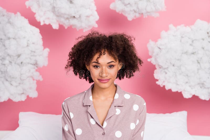 Photo of adorable cheerful lady wear pajama smiling enjoying soft clouds isolated pink color background. Photo of adorable cheerful lady wear pajama smiling enjoying soft clouds isolated pink color background.