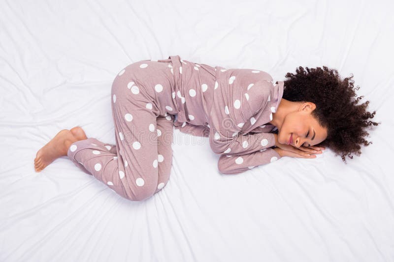 Photo of adorable pretty lady wear pajama lying bed arms hands cheek cheekbone isolated white color background. Photo of adorable pretty lady wear pajama lying bed arms hands cheek cheekbone isolated white color background.