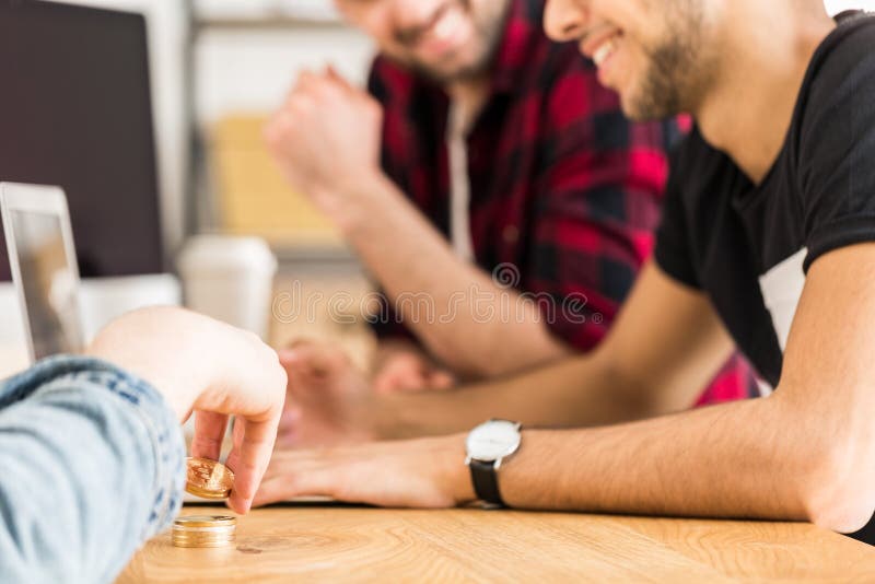 Foto colhida dos amigos que sentam-se em uma tabela e que jogam com gol fotografia de stock