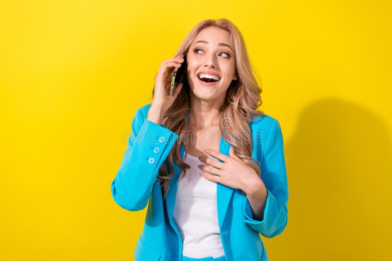 Photo of lovely astonished cheerful lady talk chatting telephone hand touch chest unbelievable news isolated on yellow color background. Photo of lovely astonished cheerful lady talk chatting telephone hand touch chest unbelievable news isolated on yellow color background.