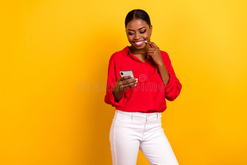 Photo of young charming girl share comment use mobile finger touch chin isolated over yellow color background. Photo of young charming girl share comment use mobile finger touch chin isolated over yellow color background.