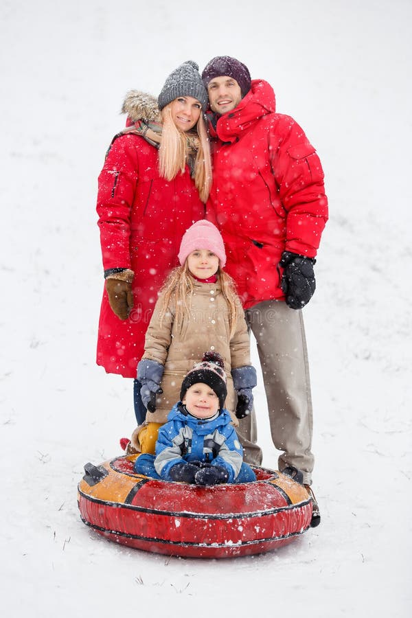 A foto de pais felizes com filha e o filho no inverno andam fotografia de stock royalty free A foto de pais felizes com filha e o filho no inverno andam fotografia de stock royalty free