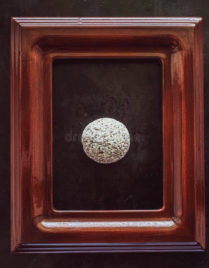 River stone of white color in a frame from a picture. the concept of certainty, stability, inviolability, immutability, fortress. photo of stone in the frame. River stone of white color in a frame from a picture. the concept of certainty, stability, inviolability, immutability, fortress. photo of stone in the frame