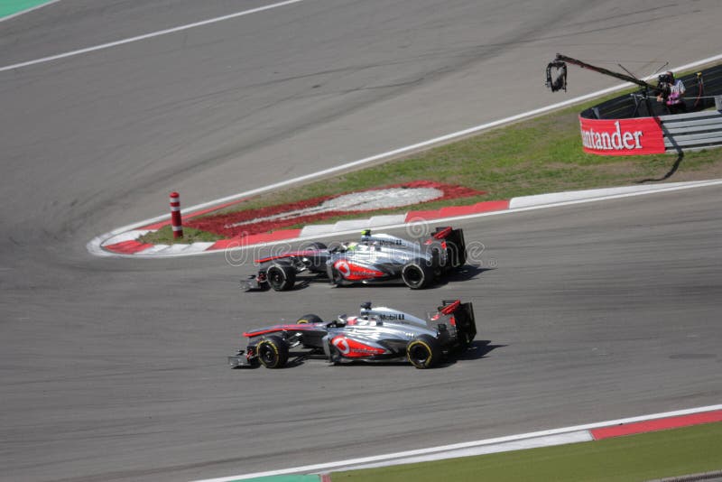 F1 Photo : Formula 1 race car overtaking - McLaren drivers Jenson Button and Sergio Perez in Germany on Nurburgring Grand Prix 2013. F1 Photo : Formula 1 race car overtaking - McLaren drivers Jenson Button and Sergio Perez in Germany on Nurburgring Grand Prix 2013