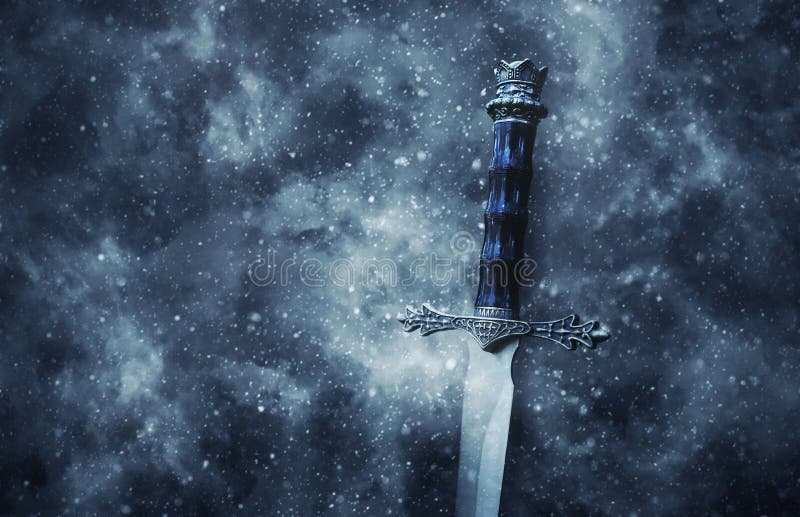 mysterious and magical photo of silver sword over gothic snowy black background. Medieval period concept. mysterious and magical photo of silver sword over gothic snowy black background. Medieval period concept