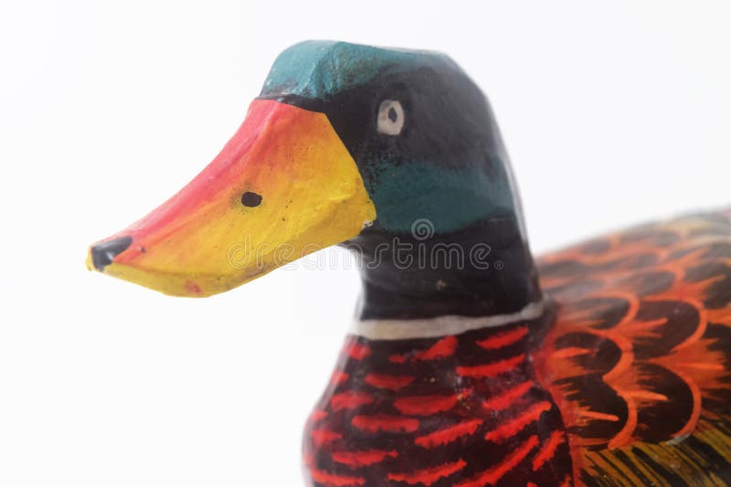 Brebes, Indonesia, June 2, 2023 : Close up photo of a typical Indonesian toy duck made of wood and painted in attractive colors, Isolated White. Brebes, Indonesia, June 2, 2023 : Close up photo of a typical Indonesian toy duck made of wood and painted in attractive colors, Isolated White