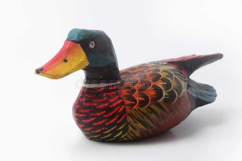 Brebes, Indonesia, June 2, 2023 : Close up photo of a typical Indonesian toy duck made of wood and painted in attractive colors, Isolated White. Brebes, Indonesia, June 2, 2023 : Close up photo of a typical Indonesian toy duck made of wood and painted in attractive colors, Isolated White