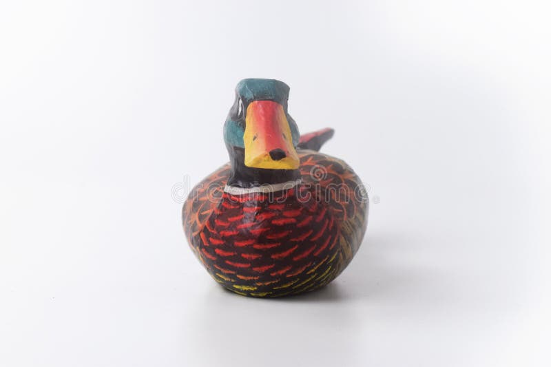 Brebes, Indonesia, June 2, 2023 : Close up photo of a typical Indonesian toy duck made of wood and painted in attractive colors, Isolated White. Brebes, Indonesia, June 2, 2023 : Close up photo of a typical Indonesian toy duck made of wood and painted in attractive colors, Isolated White