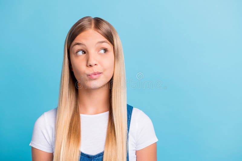 Photo portrait of child fantasizing looking at blank space isolated on pastel blue colored background. Photo portrait of child fantasizing looking at blank space isolated on pastel blue colored background.