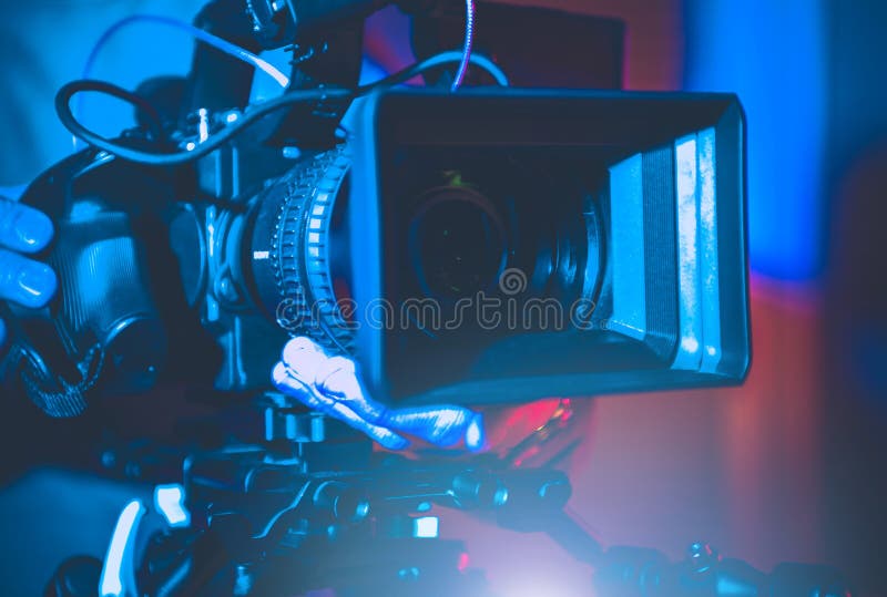 Professional Digital Motion Picture Camera in Hands of Operator. Television Studio Production Equipment. Entertainment Industry. Professional Digital Motion Picture Camera in Hands of Operator. Television Studio Production Equipment. Entertainment Industry