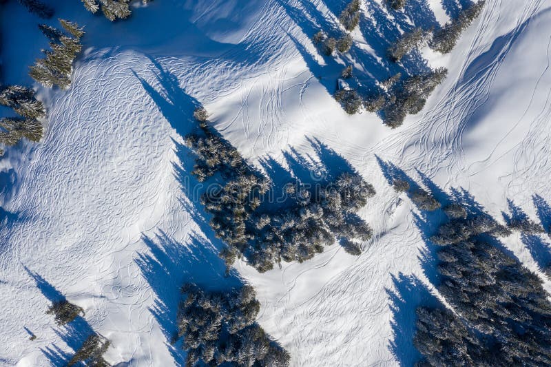 Fotografía del abejón de la snowboard y de las pistas del esquí dejadas en el alto de la nieve en montañas fotos de archivo Fotografía del abejón de la snowboard y de las pistas del esquí dejadas en el alto de la nieve en montañas fotos de archivo