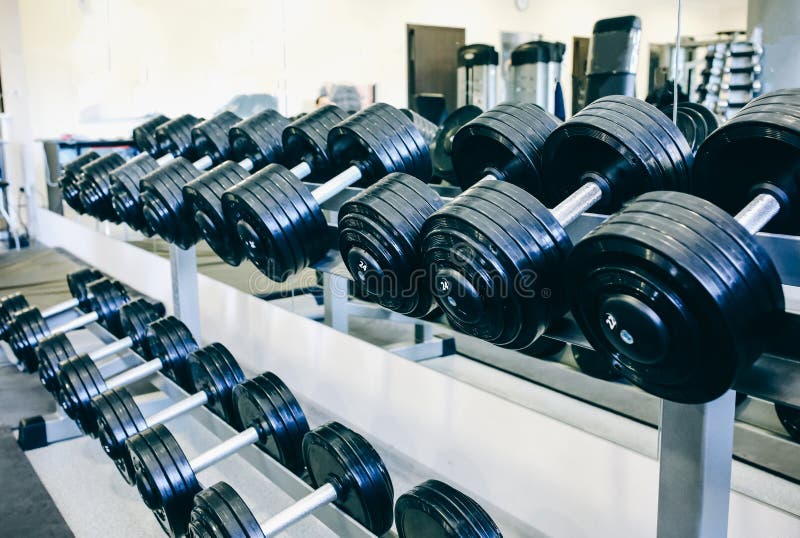 Heavy dumbbells lying in the raw in the gym. Fitness sport motivation. Happy healthy lifestyle living. Exercises with bars weights. Heavy dumbbells lying in the raw in the gym. Fitness sport motivation. Happy healthy lifestyle living. Exercises with bars weights.