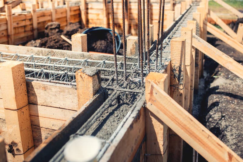 Foundation site of new house, building, details and reinforcements with steel bars and wire rod, preparing for cement pouring