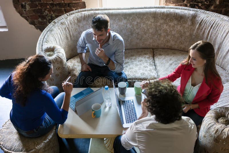 Founders of start-up business meeting on grandmas old sofa