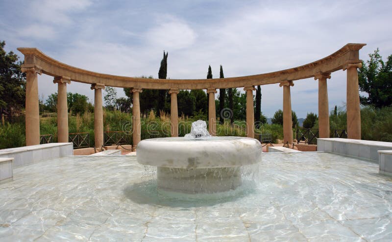 Fountain built using marble, ancient style arch on background. Pillar column garden stock images, royalty-free photos and pictures