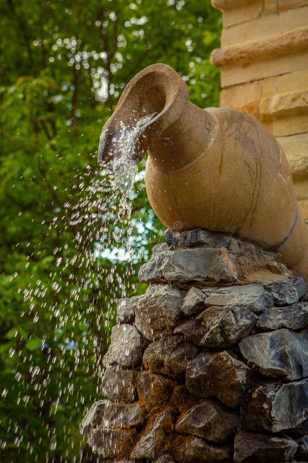 Fountain in the form of water pouring from a jug. 