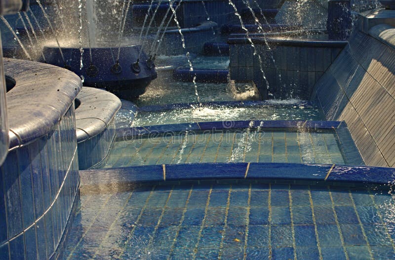 Fountain made of blue ceramic tiles with water splashing around royalty free stock image Fountain made of blue ceramic tiles with water splashing around royalty free stock image