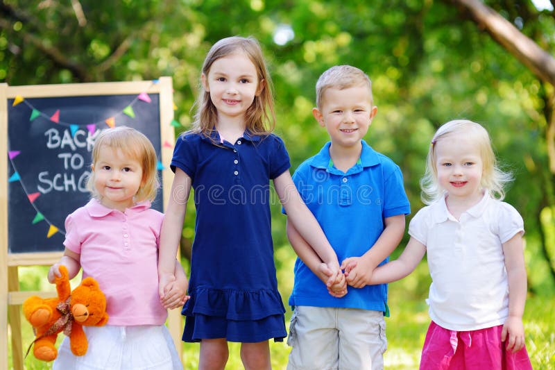 Four adorable little kids are going back to school royalty free stock photos Four adorable little kids are going back to school royalty free stock photos