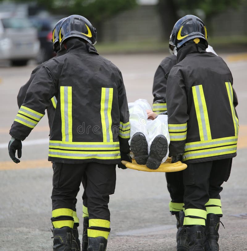 Four brave firemen transport the injured with a stretcher