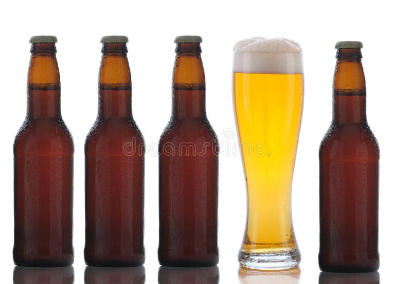 Four Brown Beer Bottles and Full Glass royalty free stock photo
