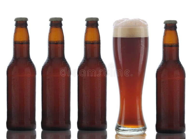 Four Brown Beer Bottles and Full Glass royalty free stock photo